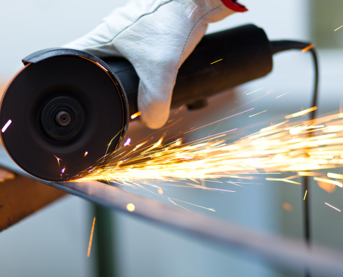 Worker using a grinder